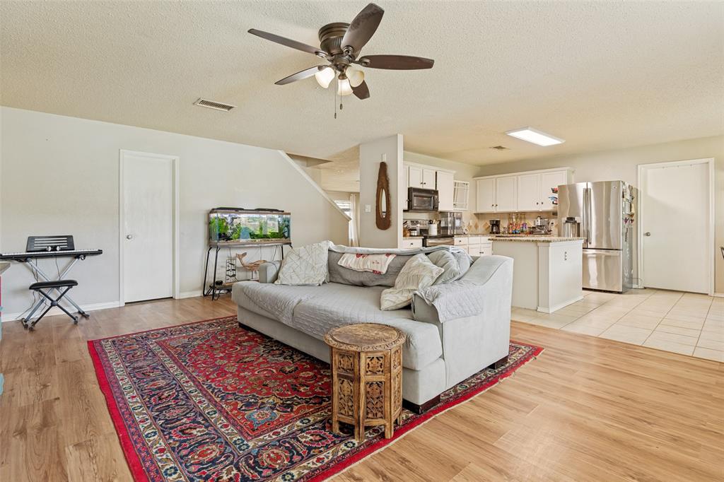 Open-concept living space featuring wood-finish flooring
