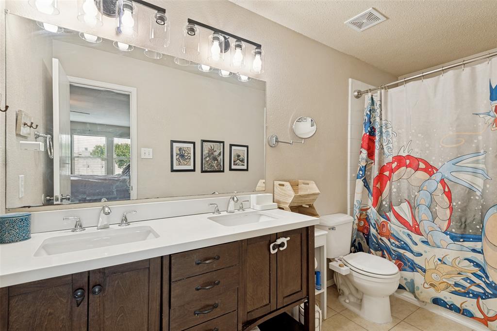 Dual vanity with white undermount sinks, chrome fixtures, and a spacious framed mirror
