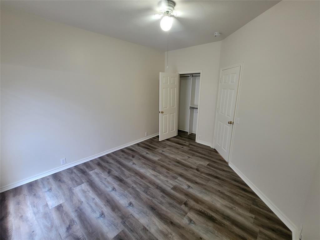2nd bedroom with walk-in closet and new laminate flooring