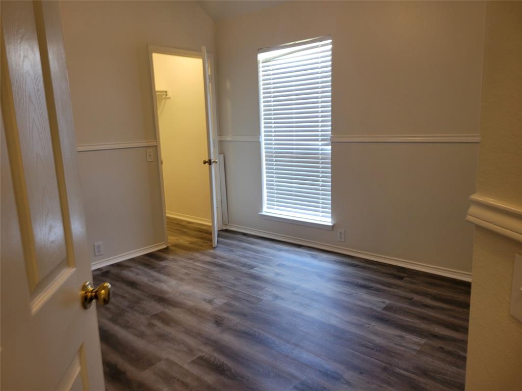 3rd bedroom with large walk-in closet and new laminate flooring