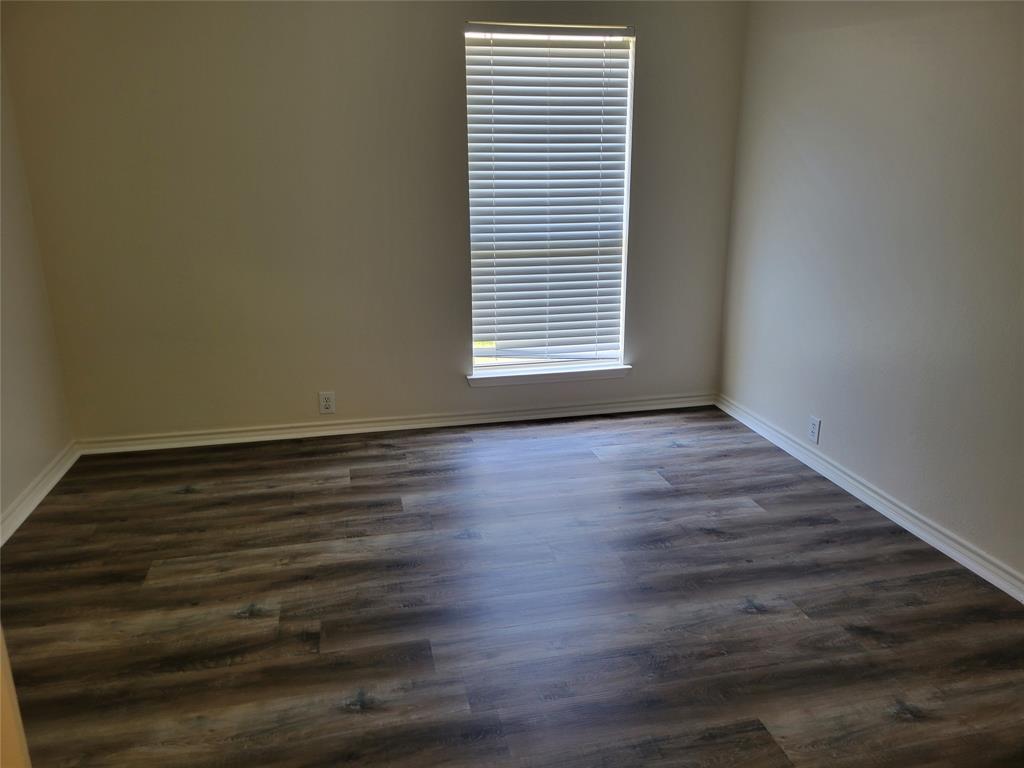 3rd bedroom with large walk-in closet and new laminate flooring