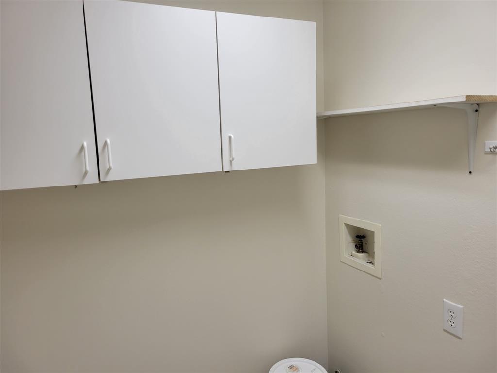 Laundry area with hookup for a washing machine and cabinets