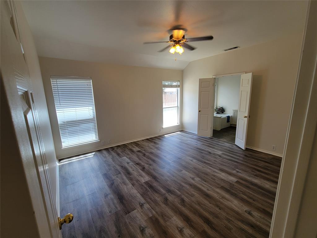 Master with new laminate flooring, large walk-in closet and ceiling fan