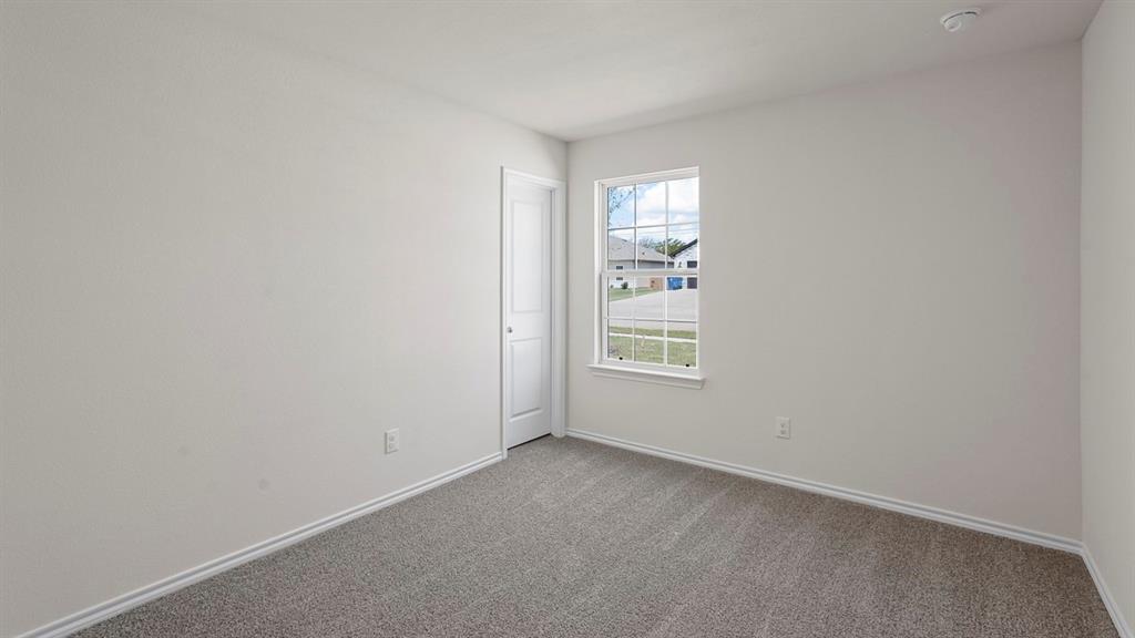 Bedroom featuring light gray walls, gray carpet, white trim, and a white framed window