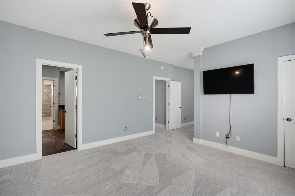 Light-colored carpeting with a contemporary ceiling fan and recessed lighting