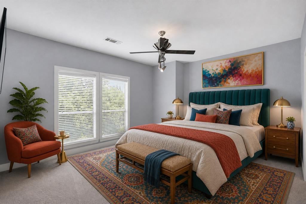 Primary Bedroom with Teal Upholstered Headboard, Ceiling Fan with Integrated Lighting, Large Glass Doors with Plantation Shutters, Hardwood Nightstands, and Patterned Area Rug Anchoring the Space