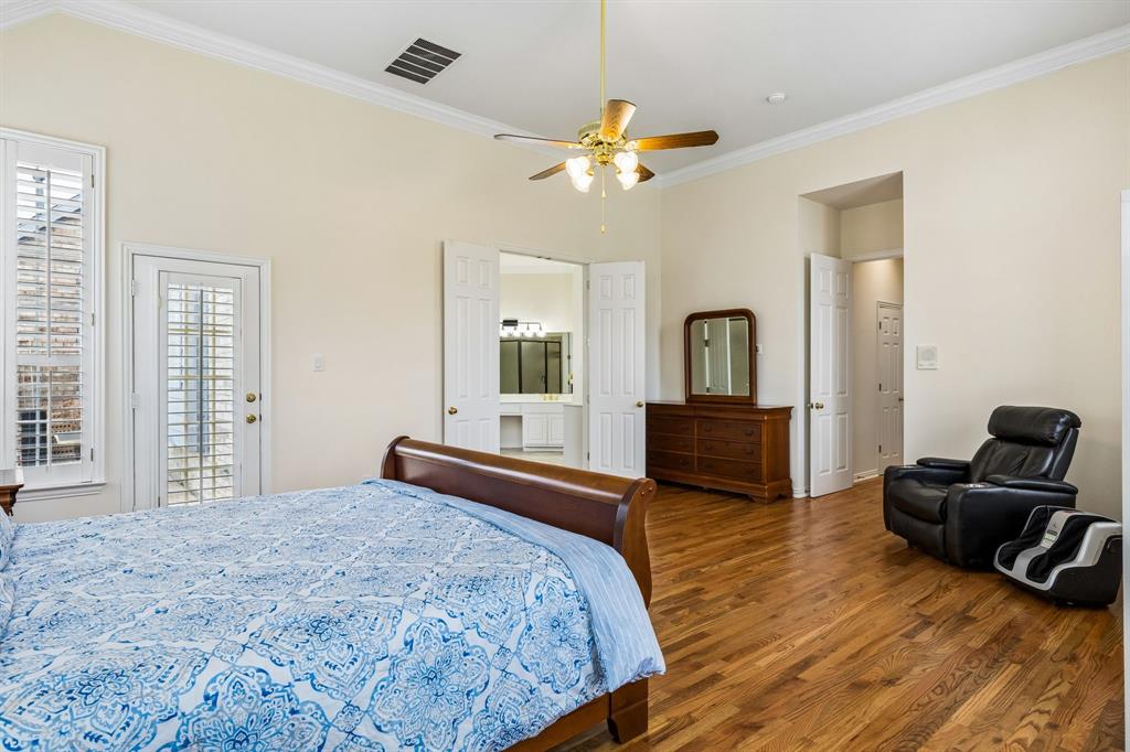 Retreat to the spacious primary suite, where rich wood flooring adds warmth and elegance throughout. Designed for both comfort and relaxation, this oversized bedroom offers plenty of room for large furnishings while still feeling open and inviting.