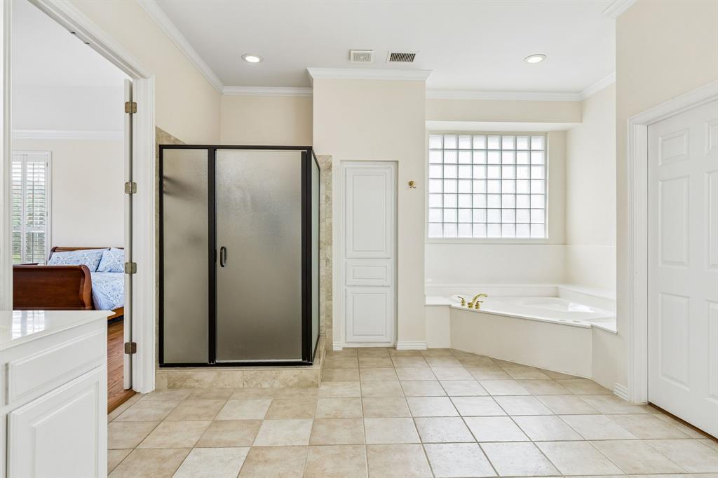 A soothing tub invites relaxation, while the separate shower adds a touch of everyday luxury. Spacious, refined, and thoughtfully designed, this is the perfect place to begin and end each day.