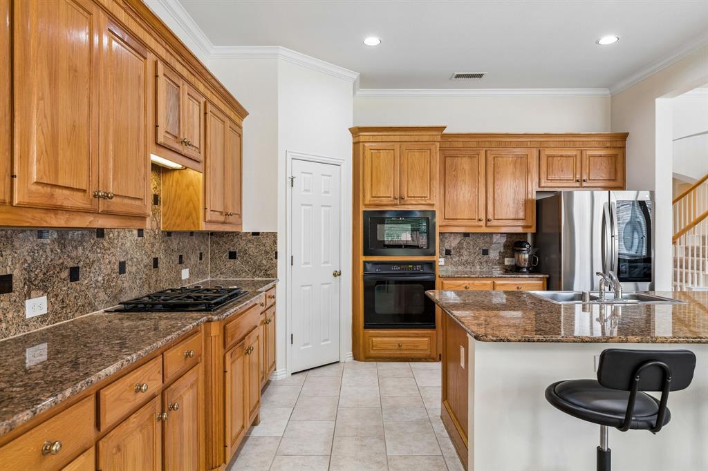 A gourmet kitchen that will no doubt inspire your inner chef with its gorgeous counters, ample cabinets, stainless steel appliances, gas stovetop, walk-in pantry and island.
