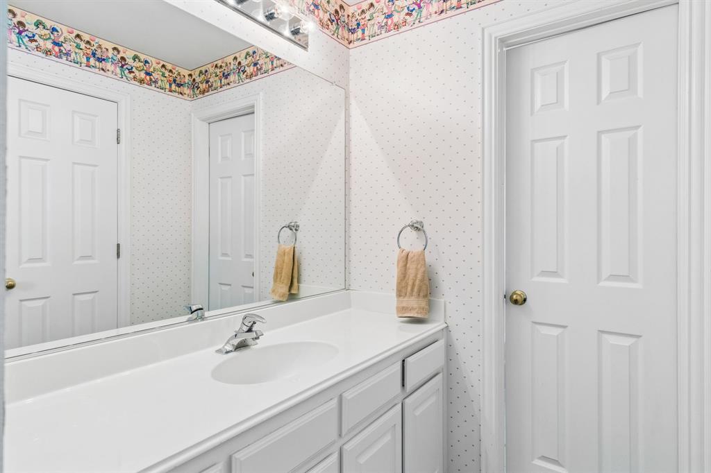 A full bath on the second level with a tub/shower combination, vanity, and ample storage cabinetry.