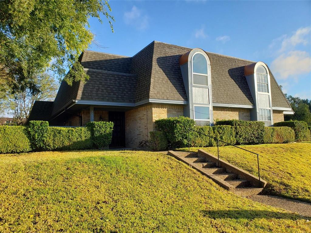 Front view of home set up above the street level.