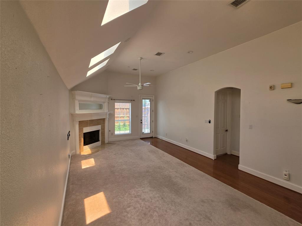 Living area with vaulted ceilings and a white ceiling fan