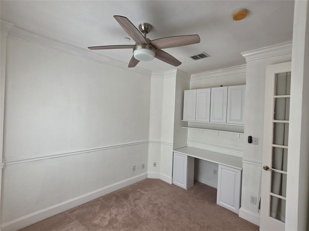 Built-in desk with integrated white cabinetry and shelving