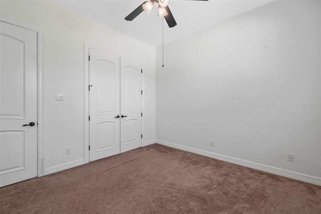 Neutral tone walls with brown carpet flooring