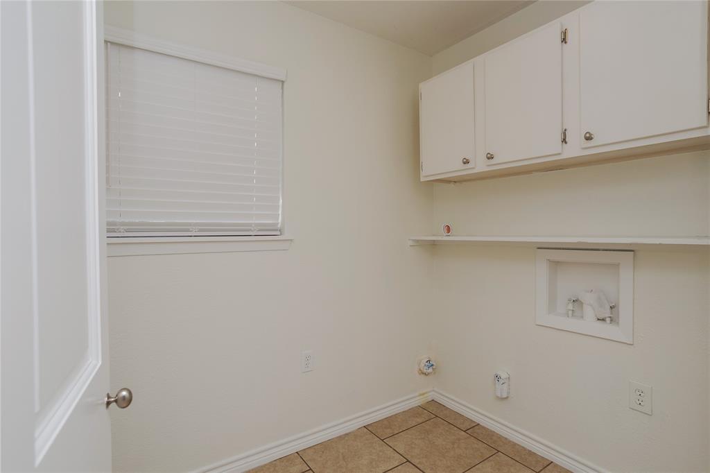 Spacious laundry room, with good storage.