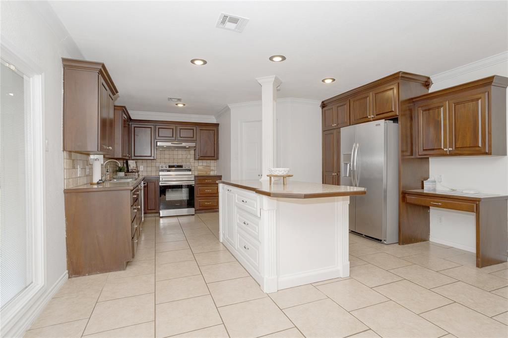 Another view of the kitchen, showing the island and Frigidaire Gallery refrigerator that stays.