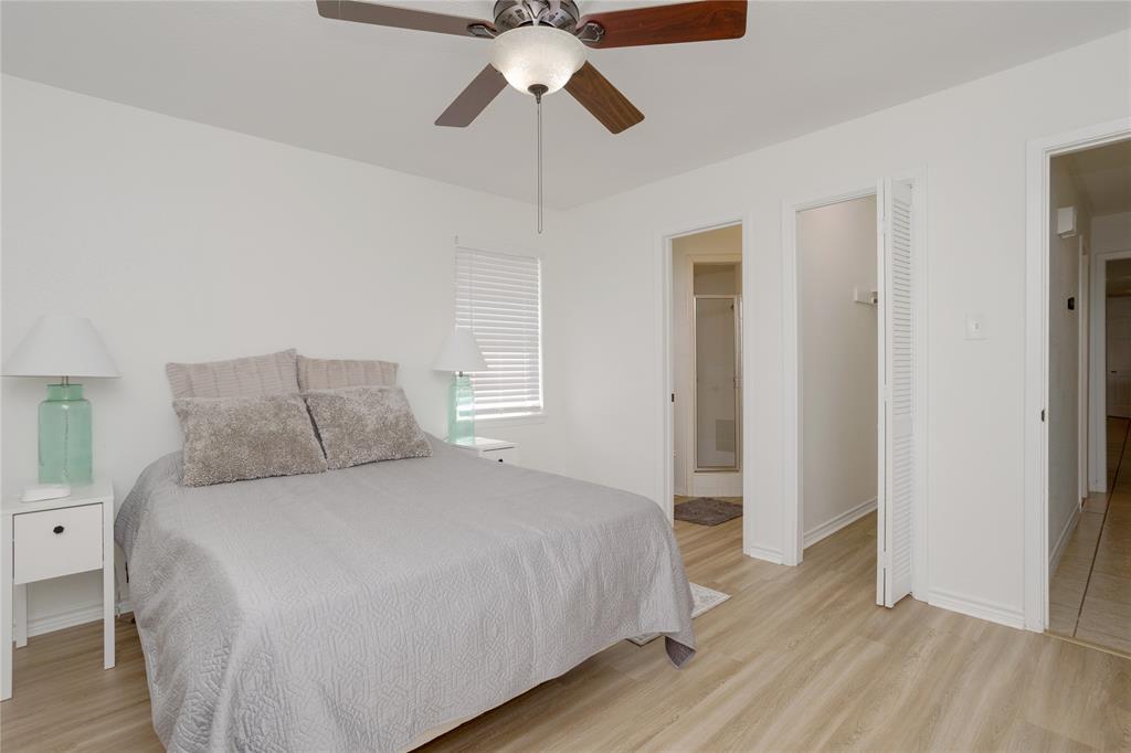 Primary bedroom showing one of the two closets and entrance to bathroom.