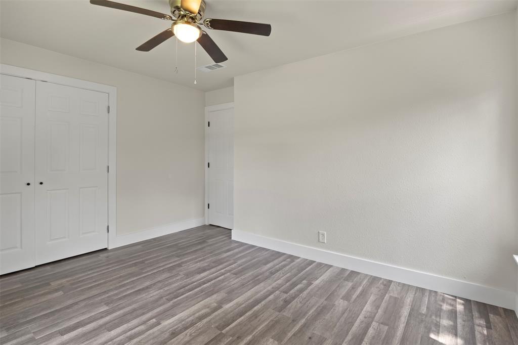 Room featuring neutral wall finishes and wood-finish flooring