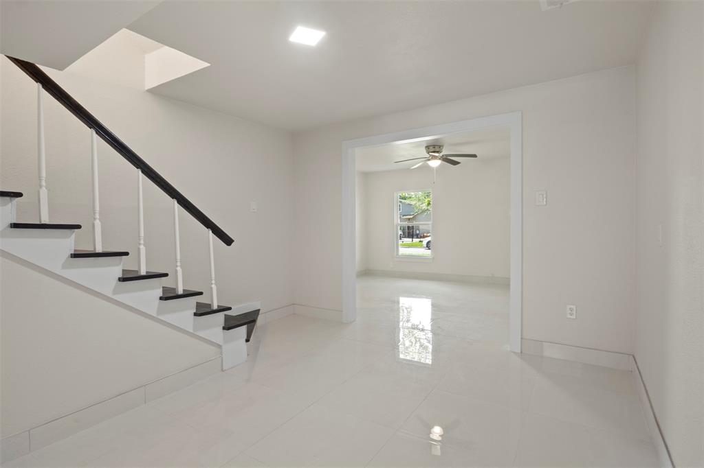 Two-tone staircase with dark treads and white risers, complemented by a dark handrail and white spindles