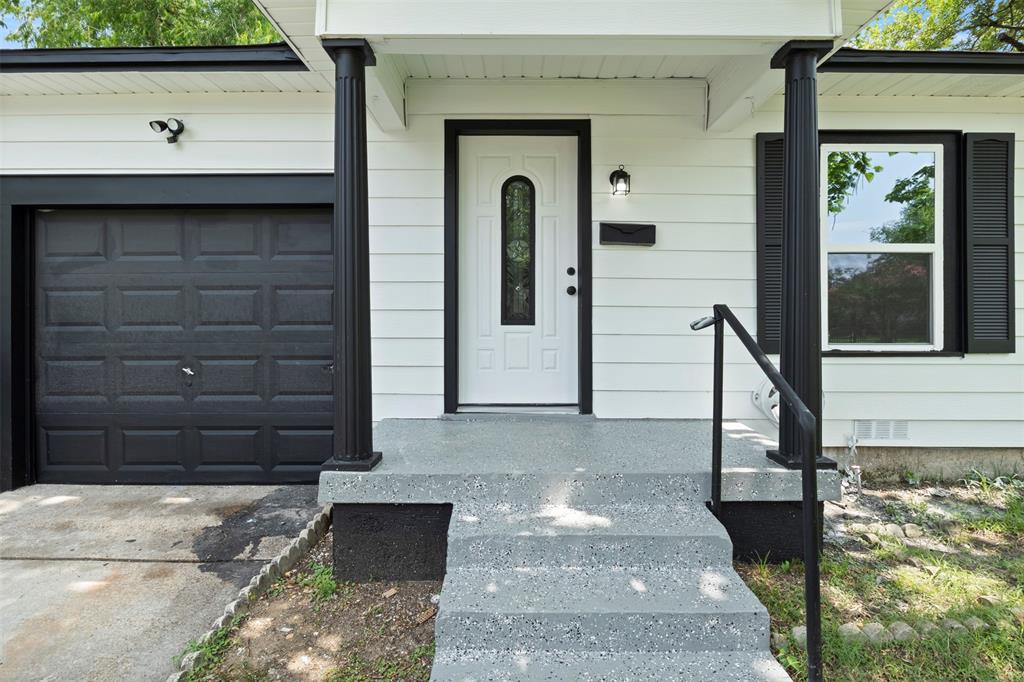 Crisp white siding with black trim accents the exterior Crisp white siding with black trim accents the exterior