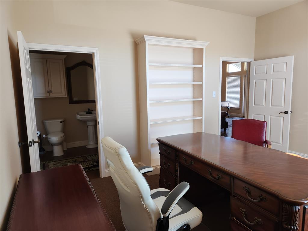 Room featuring neutral wall tones, built-in shelving, and carpet flooring