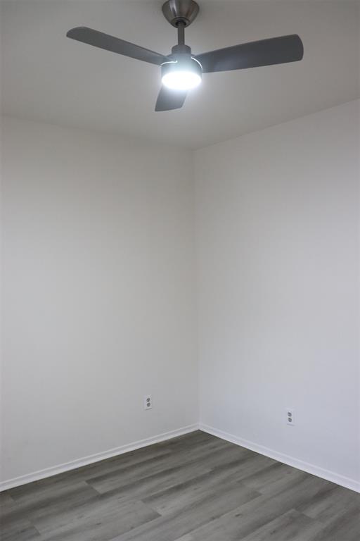 Brushed nickel ceiling fan with integrated lighting, wood-finish flooring, and crisp white walls