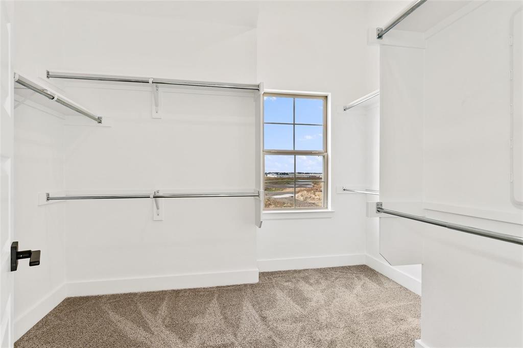 Large walk in closet with window viewing lake