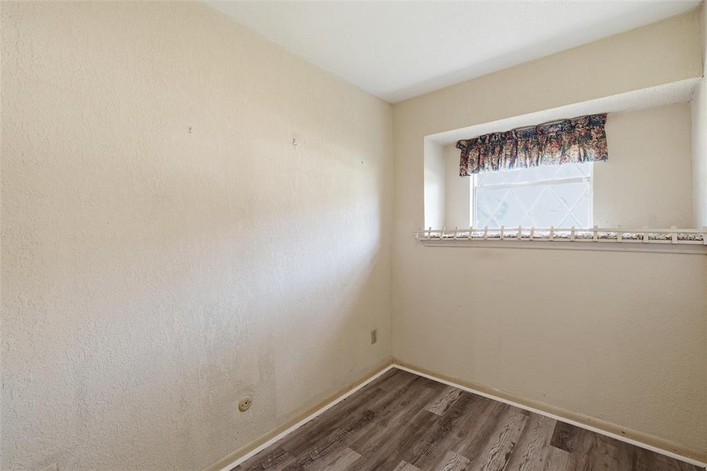 Interior room featuring wood-finish flooring and light-toned walls