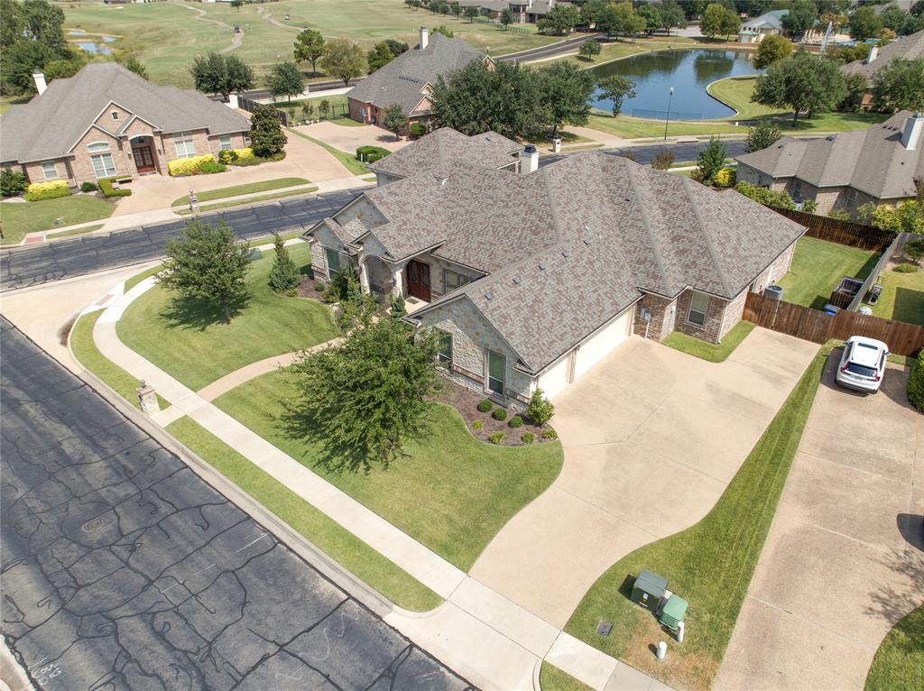 Expansive residential property featuring a stone and brick exterior with a multi-gabled roofline
