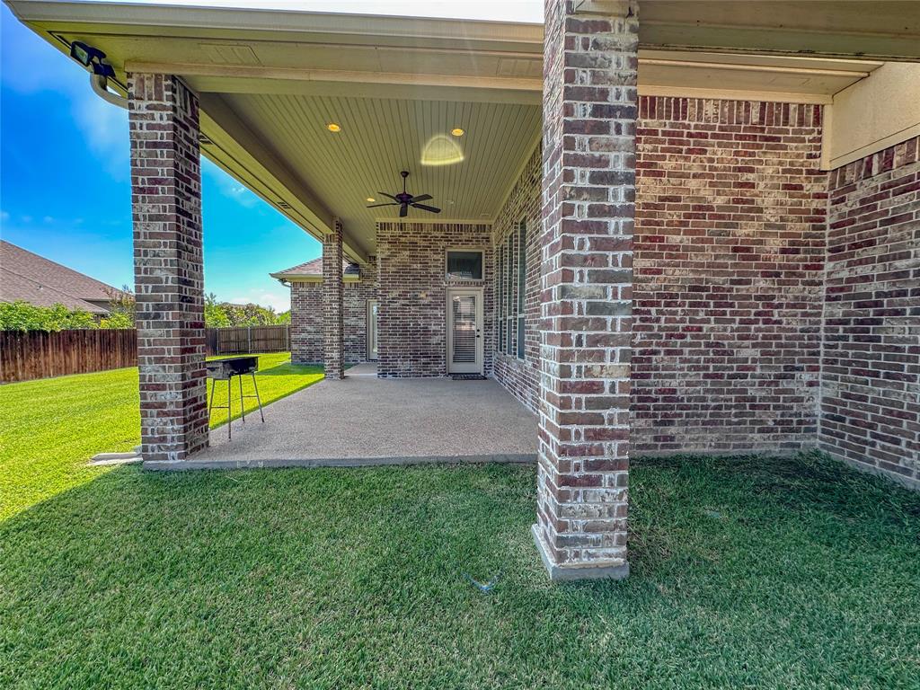 Covered patio featuring brick pillars, an outdoor ceiling fan, recessed lighting, and a concrete slab