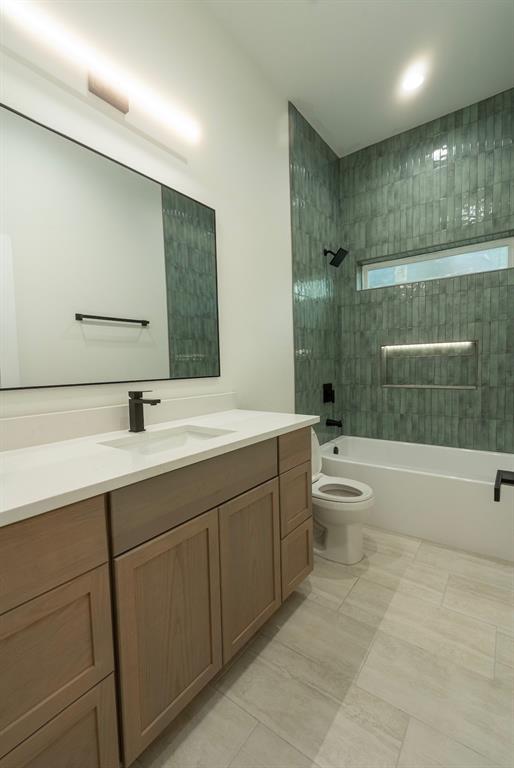 Contemporary bathroom featuring a light wood-finish vanity with a white countertop and rectangular sink