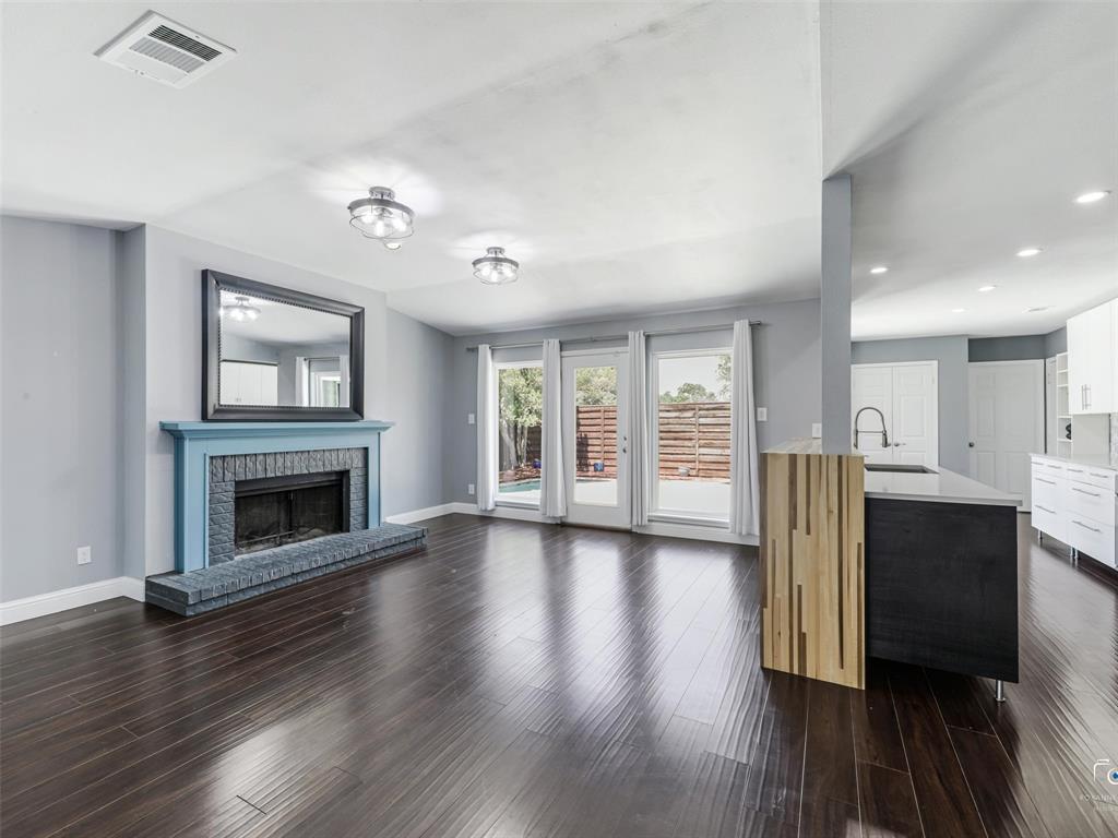 Spacious living area has a lovely fireplace with a hearth and is open to the kitchen and pool-filled backyard. Spacious living area has a lovely fireplace with a hearth and is open to the kitchen and pool-filled backyard.
