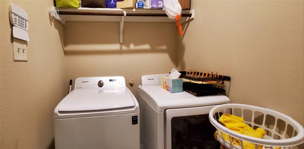 Utility area featuring a top-load washer and front-load dryer