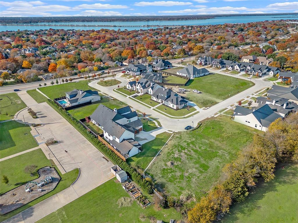 Spacious residential community with varied architectural styles, green spaces, and paved roads