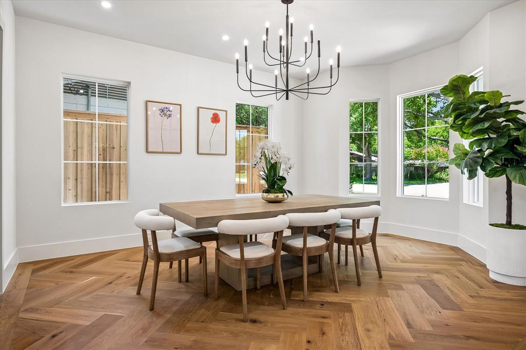 Formal dining, herringbone hardwood floor, multi-window array, chandelier
