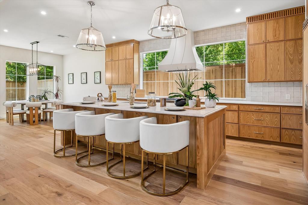 Kitchen island seating, custom hood, Mizu Silver tile backsplash, open to breakfast area