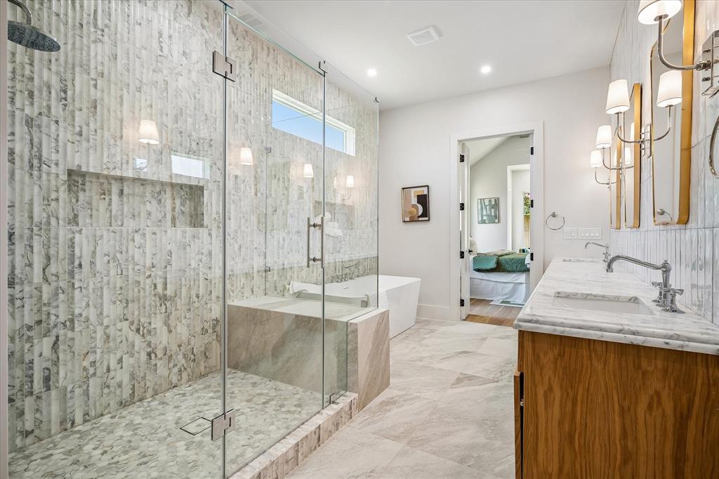 Primary bath, oversized frameless glass shower, Calacatta Giallo tile, freestanding soaking tub