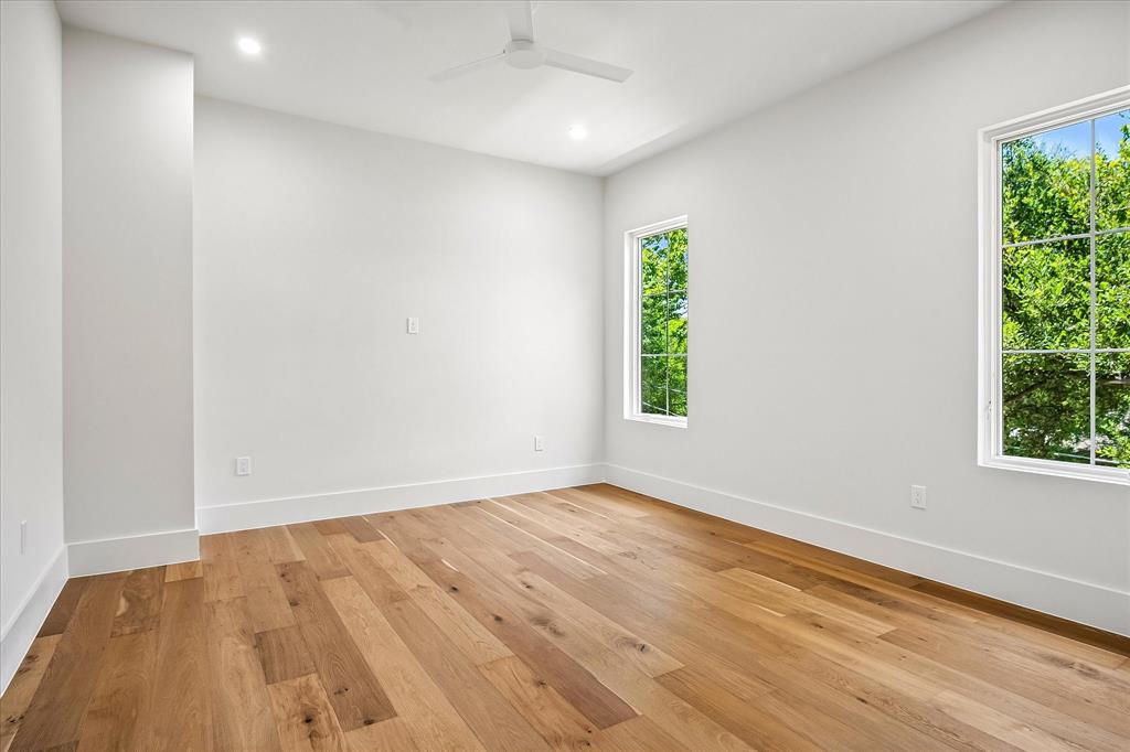 Secondary bedroom, hardwood floors, multi-window views