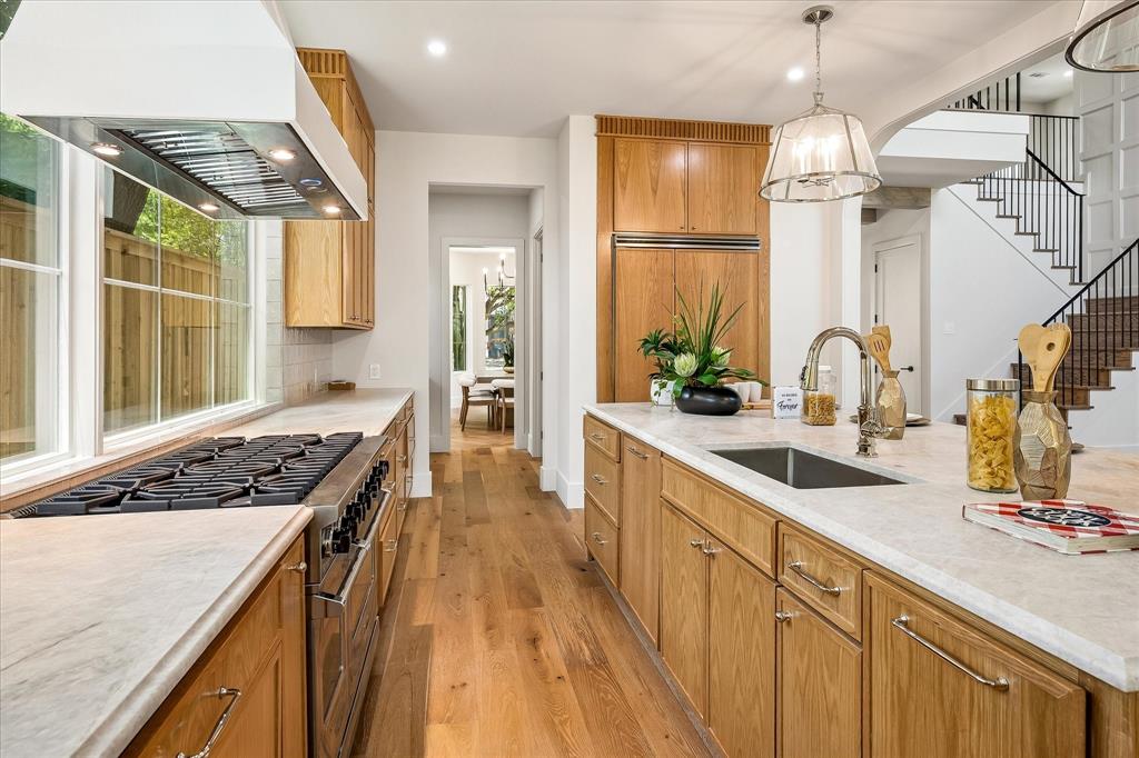 Professional range, island sink, Taj Mahal quartzite countertops
