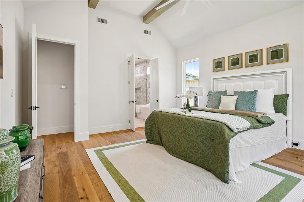 Primary suite, en suite bath entry, vaulted ceiling with exposed beams