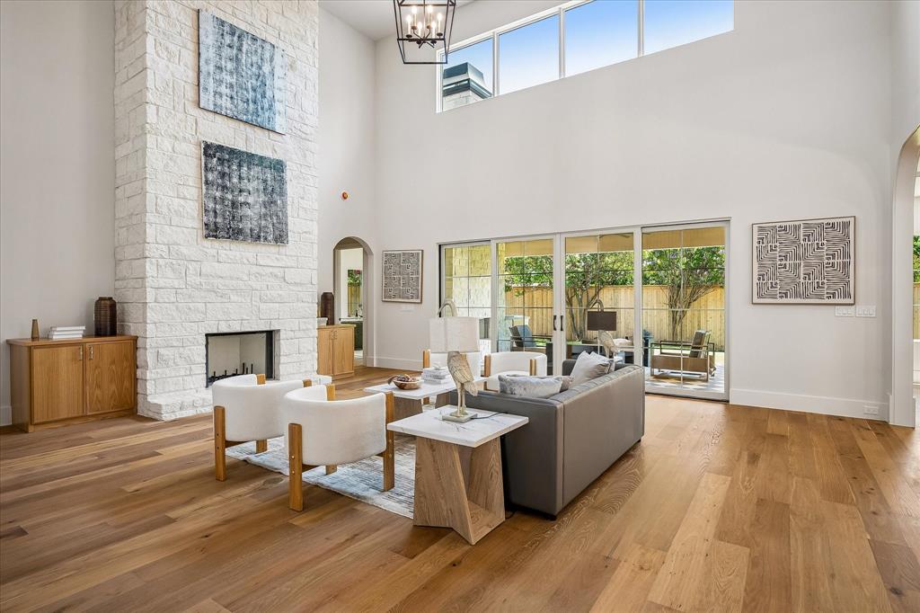 Stone fireplace, triple sliding glass doors to covered patio, hardwood floors