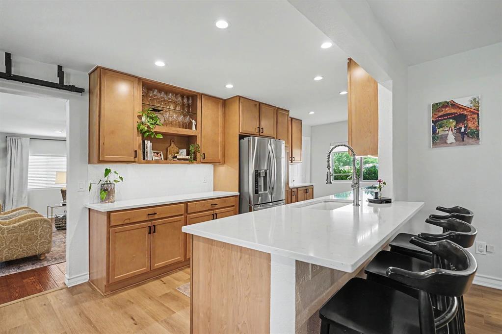 Newly updated Kitchen with quartz counter tops, recessed and motion under mount lighting. Stainless steel appliances.