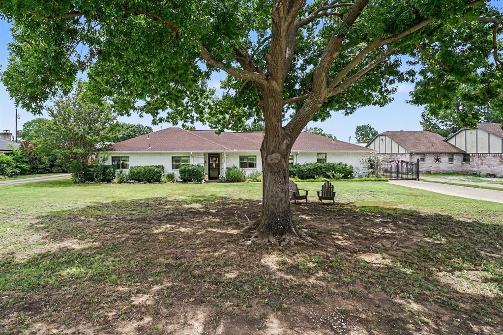 708 Summer Place, sits back on the property. Lovely Shade tree in front.