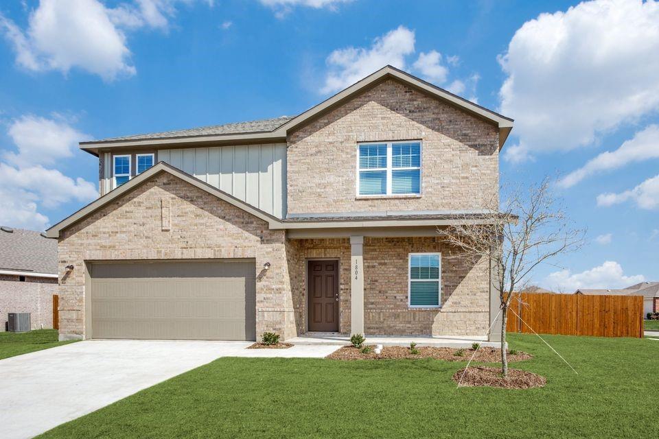 Two-story residence featuring a brick facade, covered front entry, attached garage with concrete driveway, and a fenced backyard Two-story residence featuring a brick facade, covered front entry, attached garage with concrete driveway, and a fenced backyard