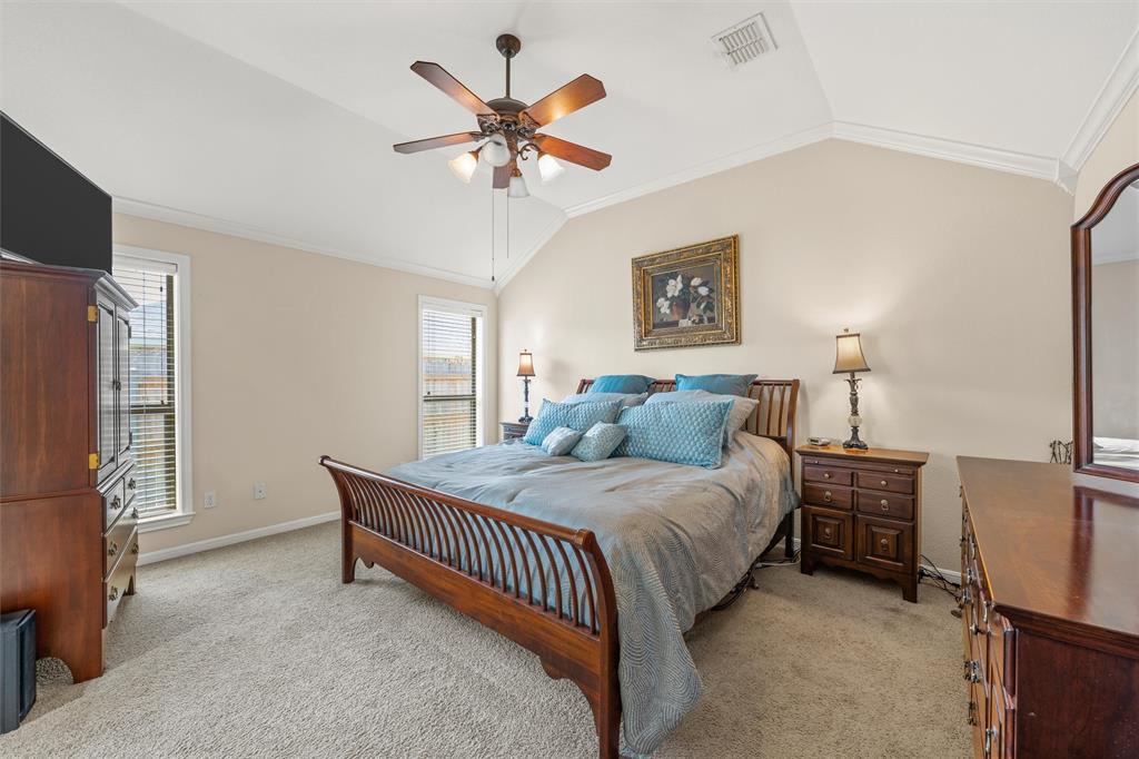 Bedroom featuring a vaulted ceiling and a ceiling fan with integrated lighting