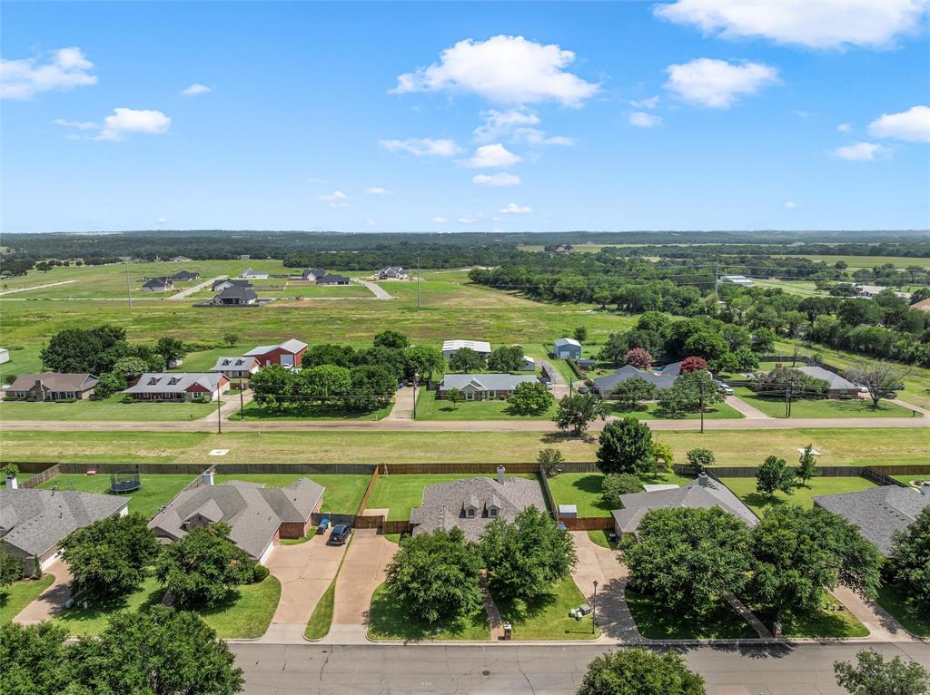 Aerial perspective showcasing a residential street with mature trees and paved driveways