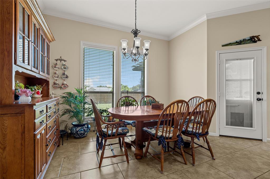 Spacious dining area featuring neutral wall tones and crown molding