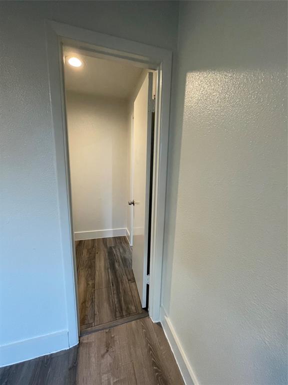Hall with dark wood-type flooring