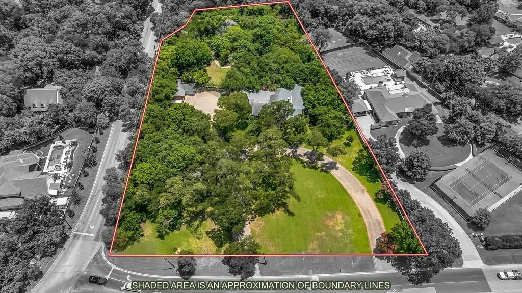 Extensive property featuring a verdant landscape with mature trees and open lawn areas