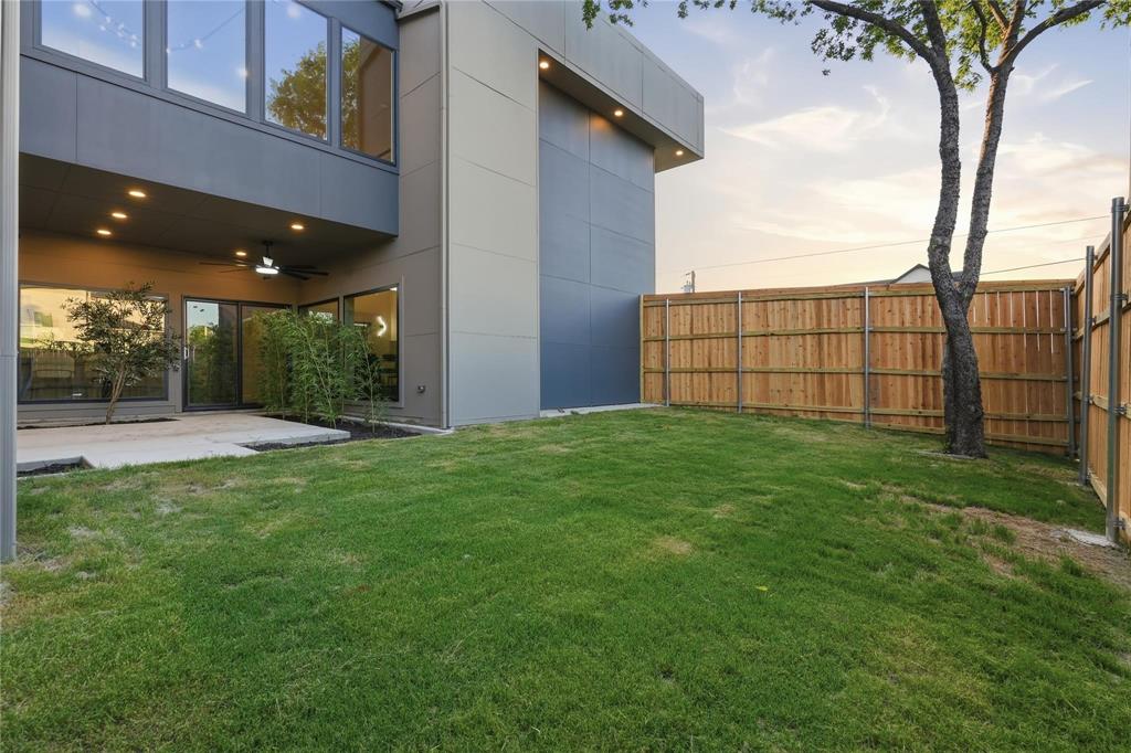 Expansive lawn with a new wood privacy fence